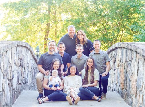 Cumming Georiga family posing at Mill Creek Pond in Alpharetta Georgia