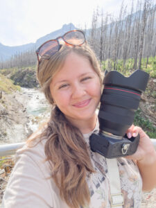 Amanda smiling holding her camera in Dallas Texas